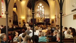 Image of Naval personnel, visiting dignitaries and members of the local community gathered in St. John's Anglican Church for a commemorative service for the loss of HMAS Perth